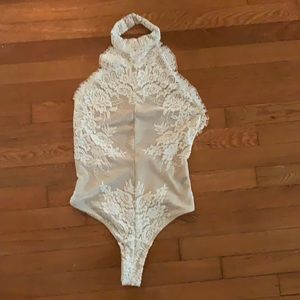 Free people high neck backless lace body suit. Never been worn